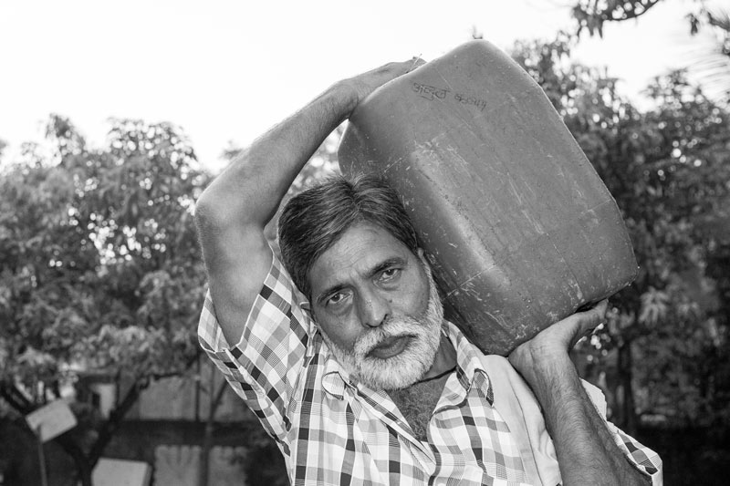 Water portraits - Even an employee of the Brihanmumbai Municipal Corporation (BMC), which is responsible for water supply in the city, needs to carry water cans for himself and his family on a regular basis – Mumbai city, Maharashtra